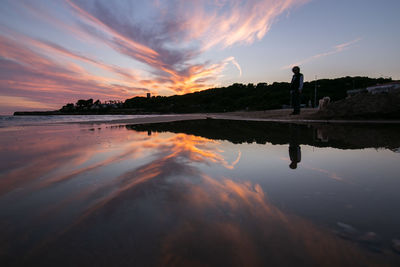 Scenic view of beach against sky during sunset