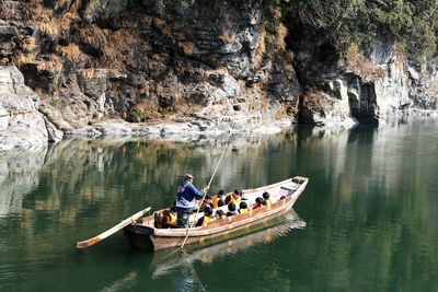 People on rock by river