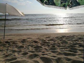 Scenic view of beach against sky during sunset