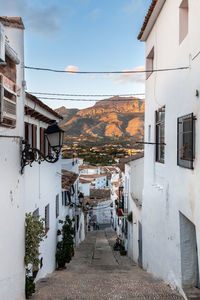 Street amidst buildings in town against sky