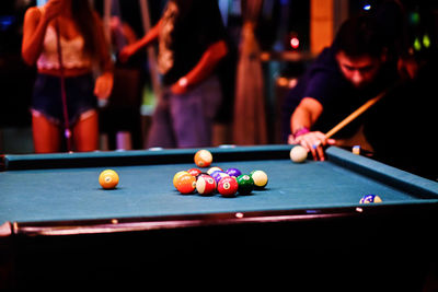 People playing with ball on table