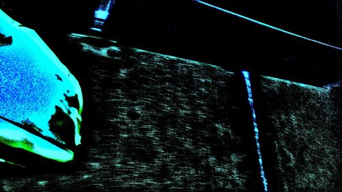 Low angle view of illuminated lights against sky at night