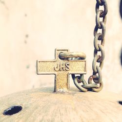 Close-up of chain on metal cross