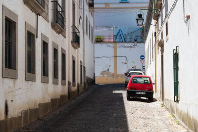 Cars on street amidst buildings in city