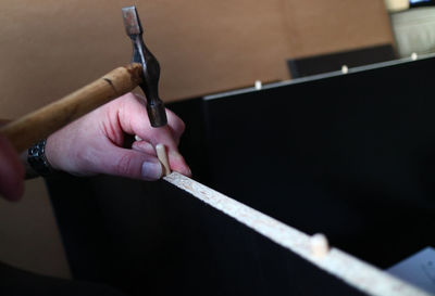 Cropped hands of carpenter working in workshop