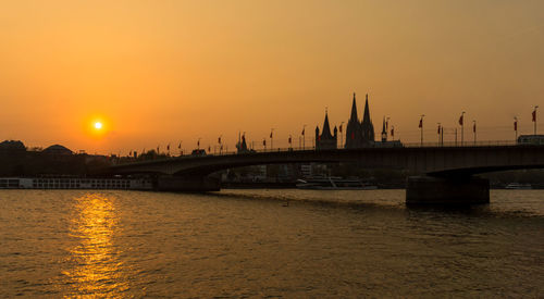 View of bridge over river against sky during sunset