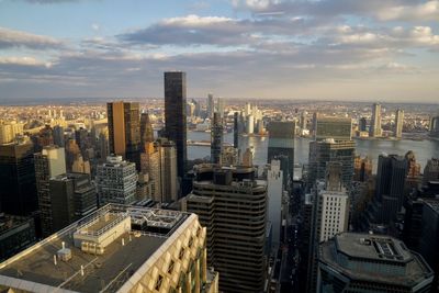 Aerial view of buildings in city against sky during sunset