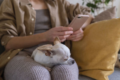 Midsection of woman using mobile phone