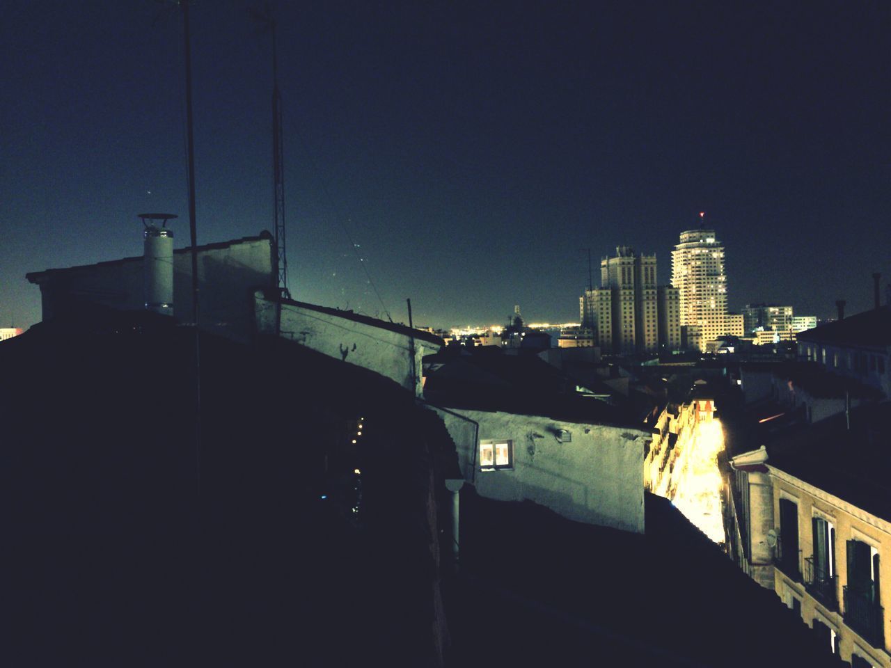 ILLUMINATED BUILDINGS AGAINST SKY AT NIGHT IN CITY