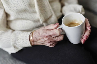 Womans hands holding mug