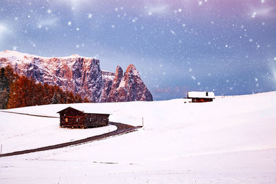 Information sign on snow covered field against sky
