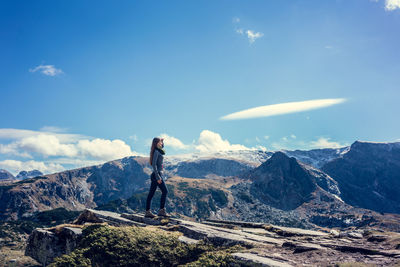 Man standing on mountain against sky