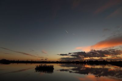 Scenic view of lake at sunset