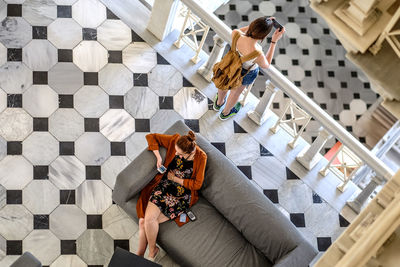 High angle view of women using mobile phone indoors