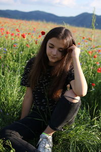 Beautiful young woman on grassy field