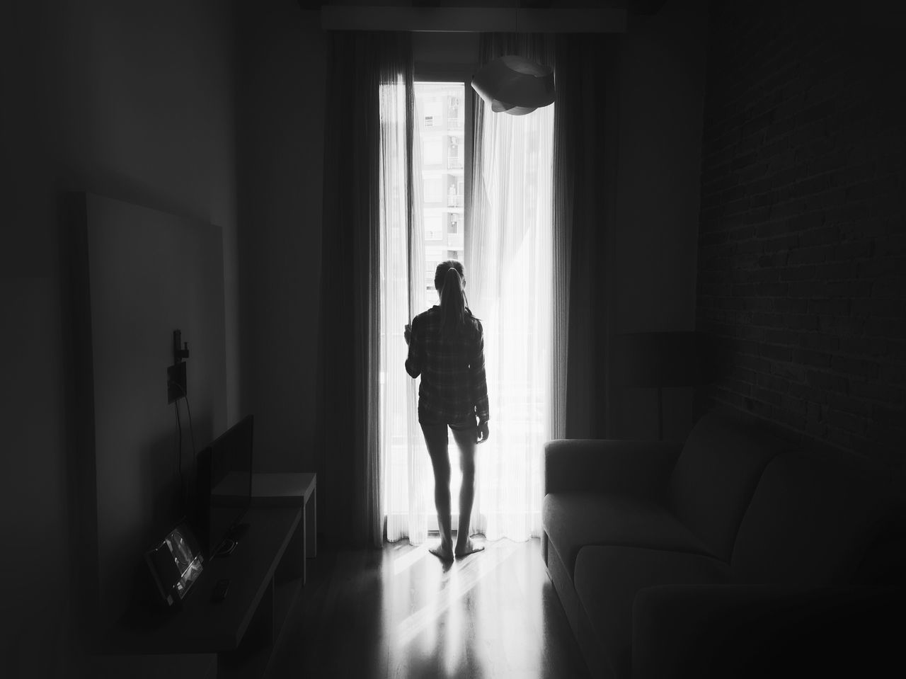 indoors, window, full length, lifestyles, rear view, home interior, door, silhouette, architecture, standing, person, men, leisure activity, corridor, built structure, sunlight, walking, doorway