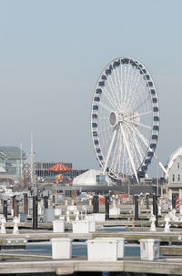 Ferris wheel in city against clear sky