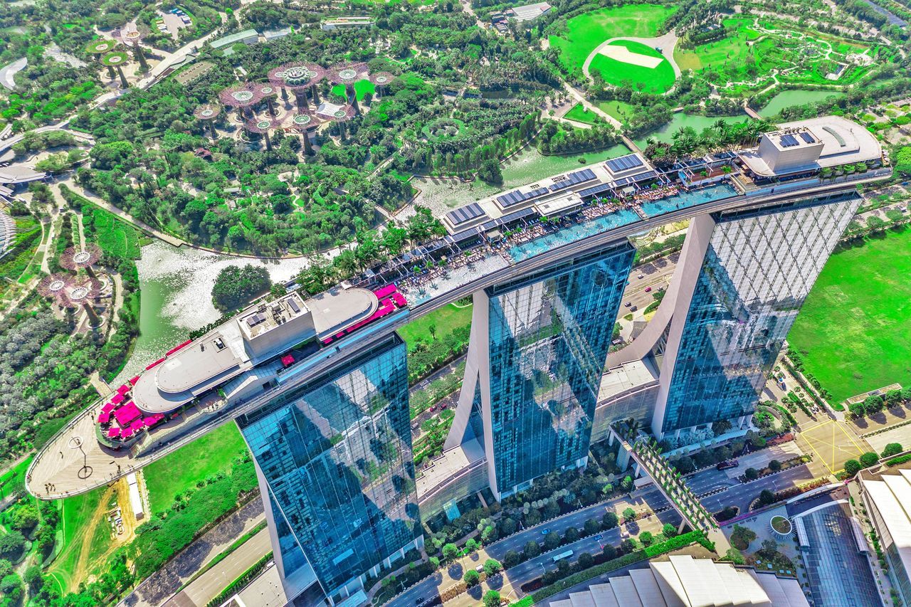 transportation, architecture, built structure, mode of transportation, high angle view, city, water, nature, connection, building exterior, bridge, tree, day, bridge - man made structure, aerial view, road, plant, travel, car, no people, outdoors, cityscape