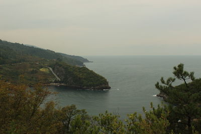 Scenic view of sea and mountains against clear sky