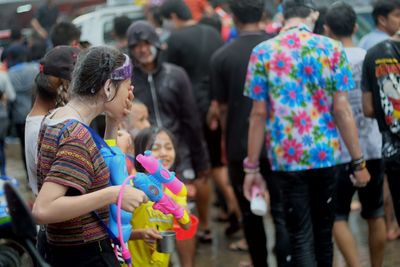 Girl holding squirt gun during songkran