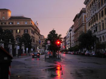 City street amidst buildings during rainy season