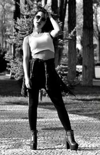 Full length of young woman standing in park