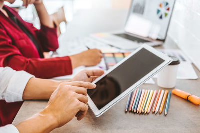 Low section of person using laptop on table