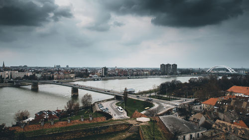 High angle view of river by buildings against sky