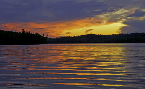 Scenic view of lake against orange sky