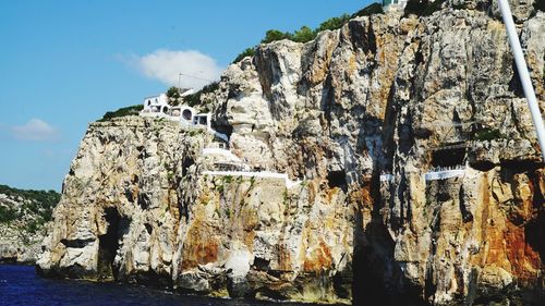 Rock formation against sky on sunny day