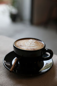 Close-up of coffee cup on table