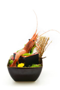 Close-up of fresh fruits in bowl against white background