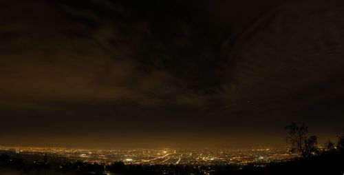 Silhouette buildings against sky at night