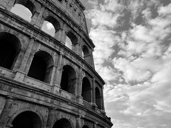 Low angle view of historical building against cloudy sky