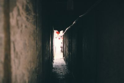 People walking in alley amidst buildings
