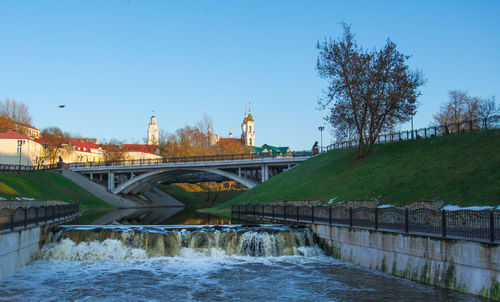 Bridge over river against blue sky