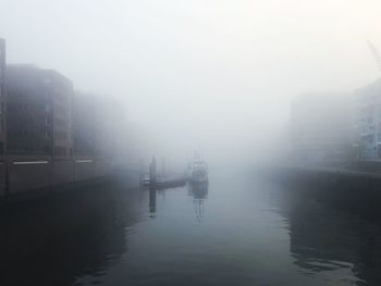 Scenic view of harbor during foggy weather