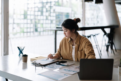 Businesswoman using laptop at office