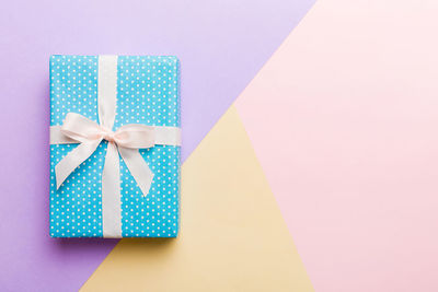 High angle view of gift box against blue background