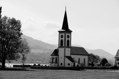 Church by building against sky