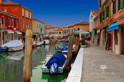 View of boats moored in city