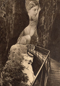 Young woman standing by tree