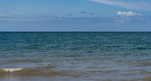 Scenic view of sea against sky with lighthouse