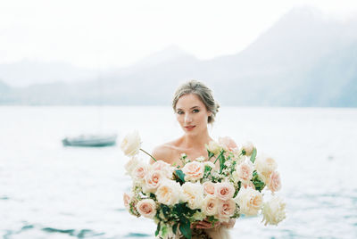 Portrait of young woman holding bouquet