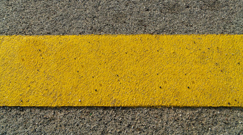 High angle view of yellow road marking on street