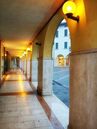 Empty corridor of illuminated building