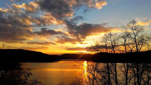 Scenic view of lake against orange sky