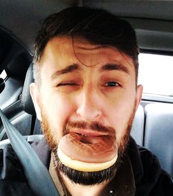 Portrait of young man in car