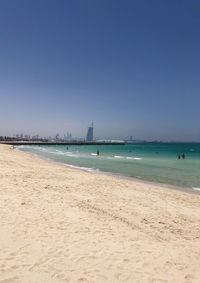 Scenic view of beach against clear blue sky