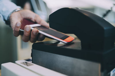 Close-up of man using smart phone